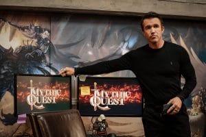 Main cast of the Mythic Quest series standing in the office of a game development studio